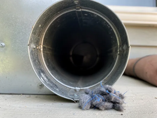 Weddington Dryer Vent Cleaning technician using specialized equipment to clear severe dryer vent blockage in Weddington
